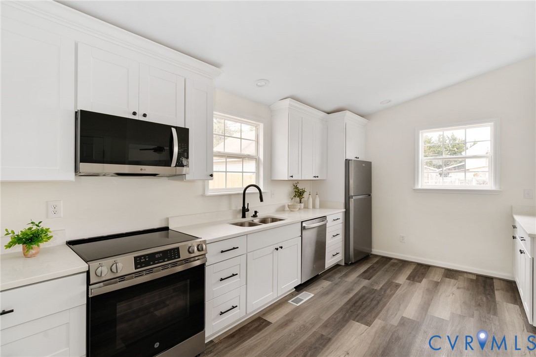 1706 Harvard Road Richmond, VA 23226 - Photo 12 of 27 a kitchen with a sink stove and microwave