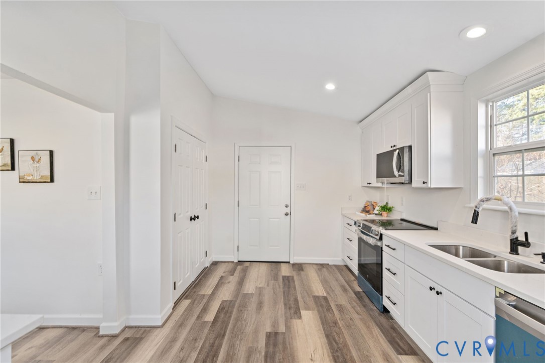 1706 Harvard Road Richmond, VA 23226 - Photo 13 of 27 a view of a kitchen with a sink wooden floor and windows