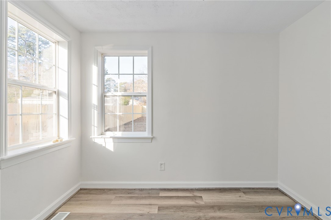 1706 Harvard Road Richmond, VA 23226 - Photo 18 of 27 a view of an empty room with wooden floor and a window