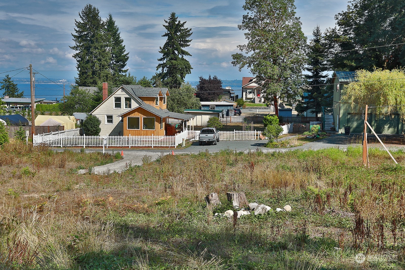 6880 Helena Street Clinton, WA 98236 - Photo 2 of 14 a view of a house with swimming pool and sitting area
