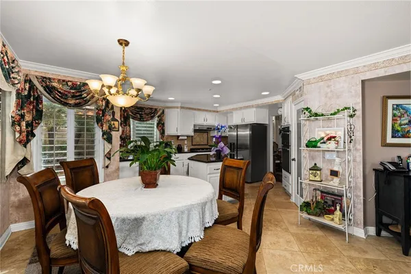 a view of a dining room with furniture and chandelier