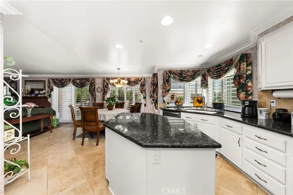 a kitchen with stainless steel appliances granite countertop a sink and a refrigerator