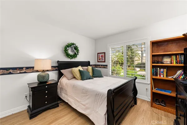 a bedroom with a bed and a book shelf
