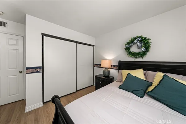 a bedroom with a bed and a potted plant