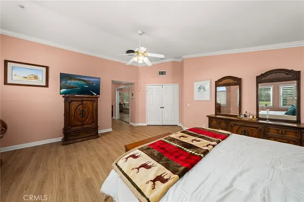 a bedroom with a bed next to a large window with the outer view