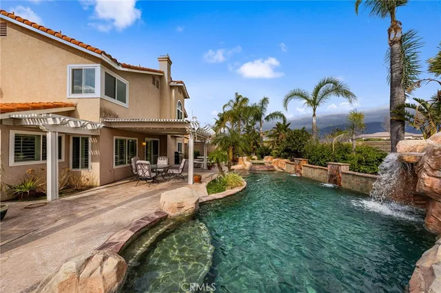 a view of a house with backyard sitting area and garden