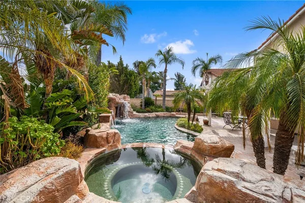 a backyard of a house with table and chairs