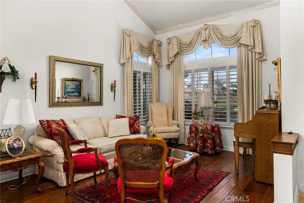 a living room with furniture a couch and large windows