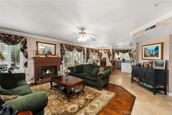 a living room with furniture a fireplace and a large window