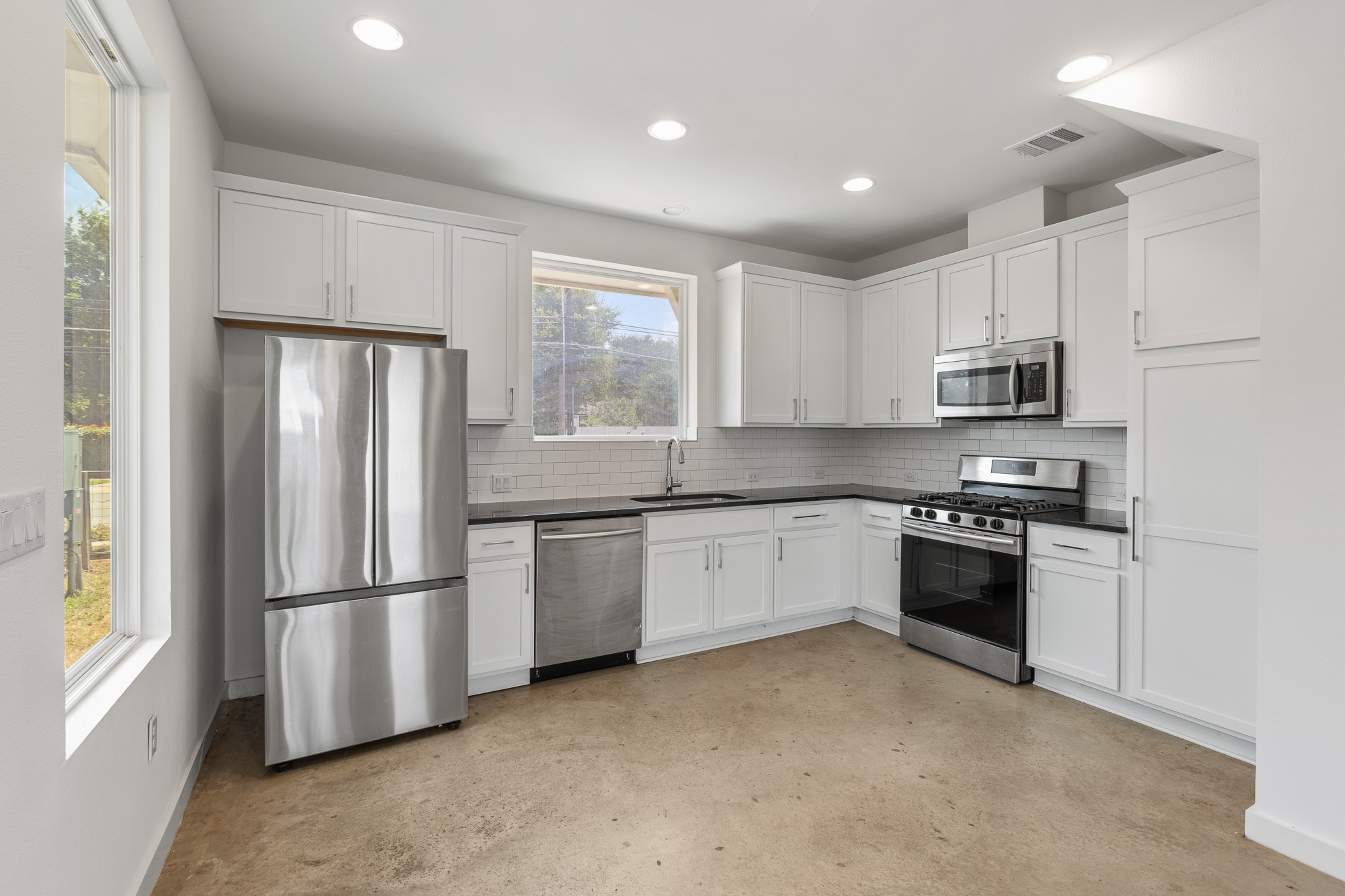 2604 Wheless Lane, Unit 1 Austin, TX 78723 - Photo 12 of 38 Clean subway tile backsplash adds timeless appeal and is easy to maintain.