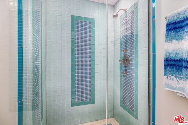 a bathroom with a shower and a sink