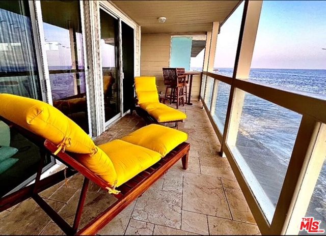 a view of a balcony with chairs