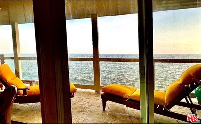 a view of living room with furniture and floor to ceiling window