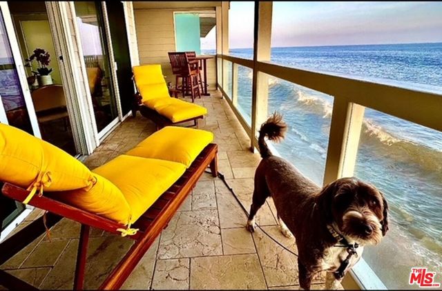a view of a balcony with furniture