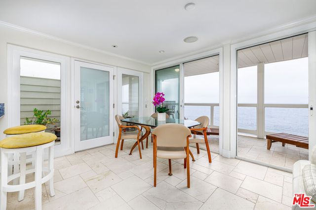 a dining room with furniture and a large window