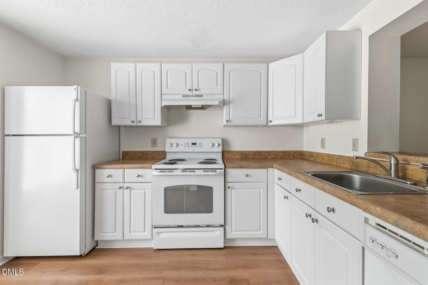 1135 Villa Green Court Raleigh, NC 27612 - Photo 6 of 17 a kitchen with cabinets appliances a sink and a counter space
