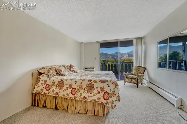 a bedroom with a bed and a large window