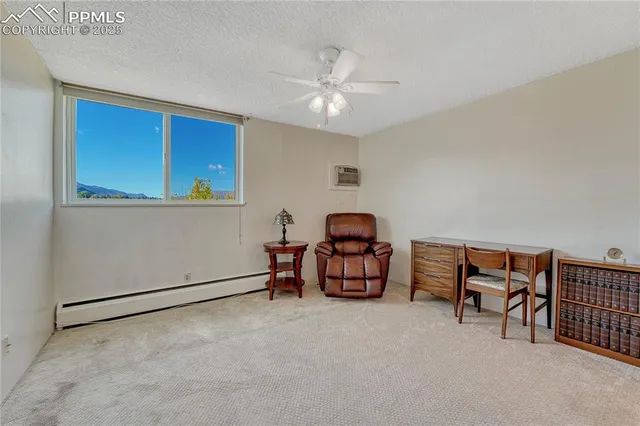 a living room with furniture a ceiling fan and a window