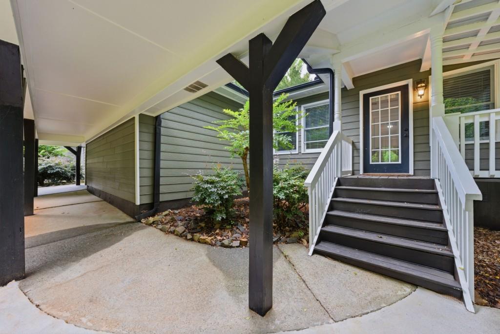 542 Knox Chapel Road Social Circle, GA 30025 - Photo 46 of 52 a view of a patio with table and chairs and a barbeque