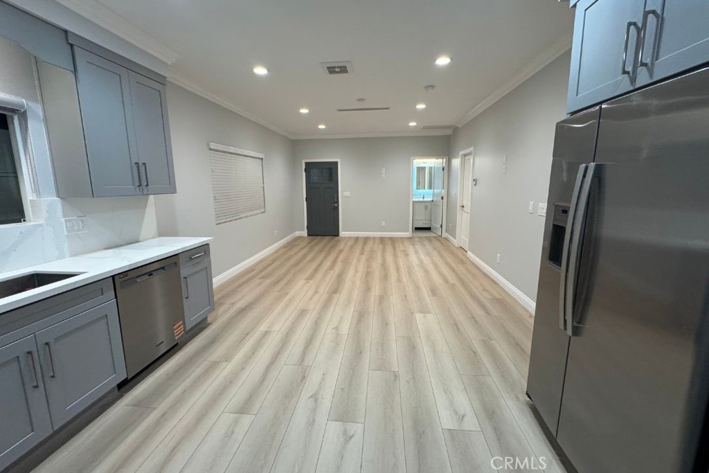 500 North Resh Place, Unit B Anaheim, CA 92805 - Photo 3 of 14 a view of kitchen with refrigerator stove and cabinets
