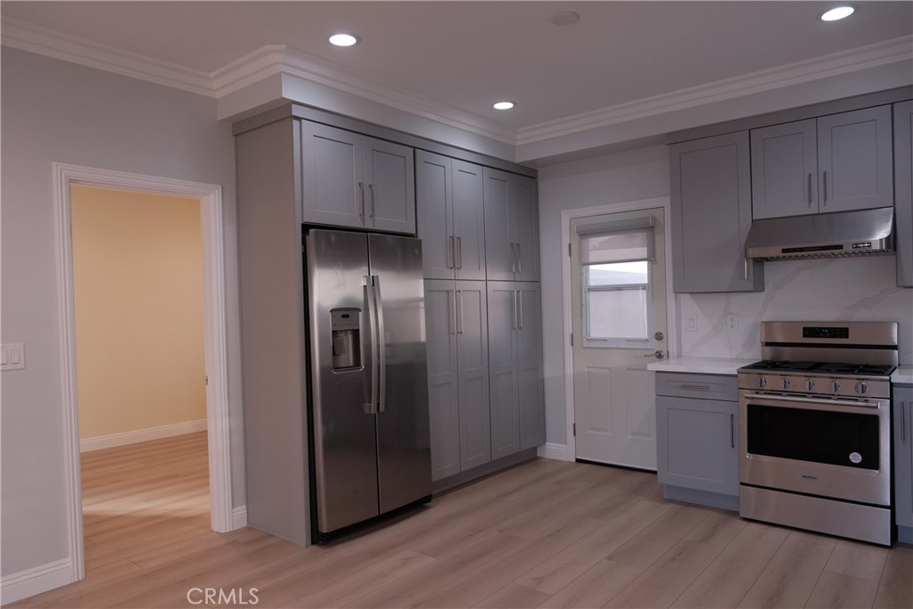 500 North Resh Place, Unit B Anaheim, CA 92805 - Photo 4 of 14 a kitchen with stainless steel appliances granite countertop a refrigerator and a stove top oven
