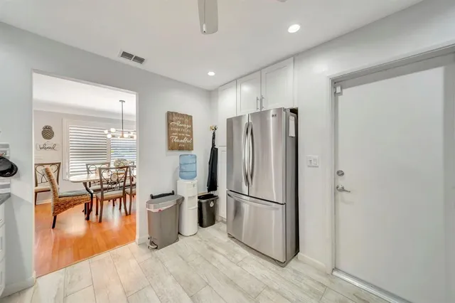 a kitchen with granite countertop white cabinets stainless steel appliances and sink