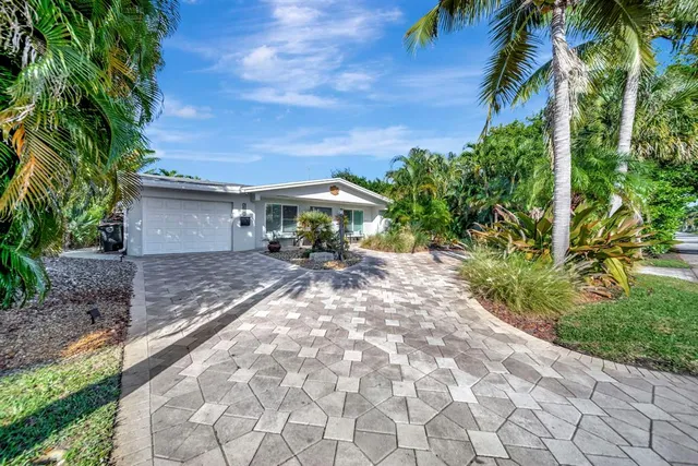 a view of a patio with table and chairs under an umbrella