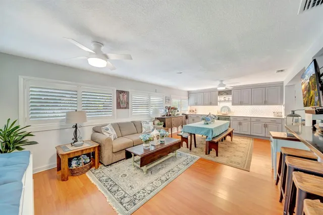 a kitchen with stainless steel appliances granite countertop a sink dishwasher stove and cabinets with wooden floor