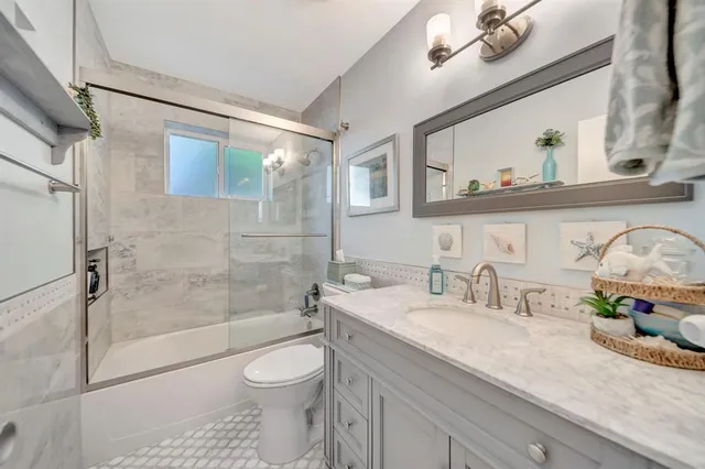 a kitchen with a stove a sink and cabinets