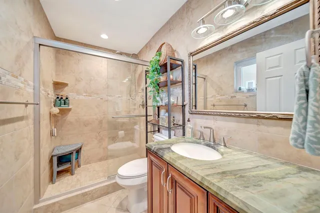 a kitchen with white cabinets and refrigerator