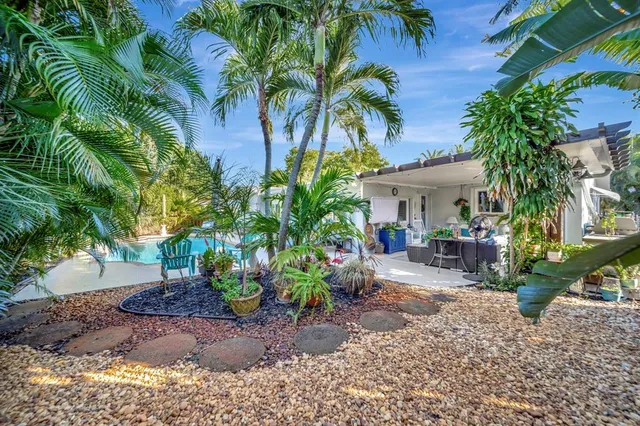 a view of house with backyard and outdoor seating