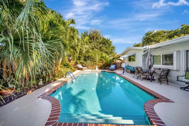 a living room with furniture a large window and a flat screen tv