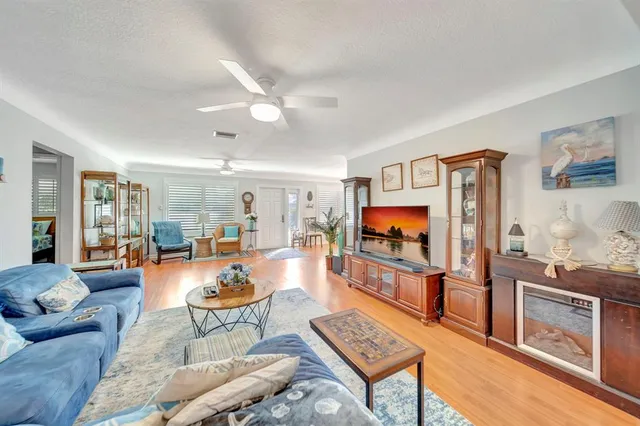 a living room with furniture a dining table and a window