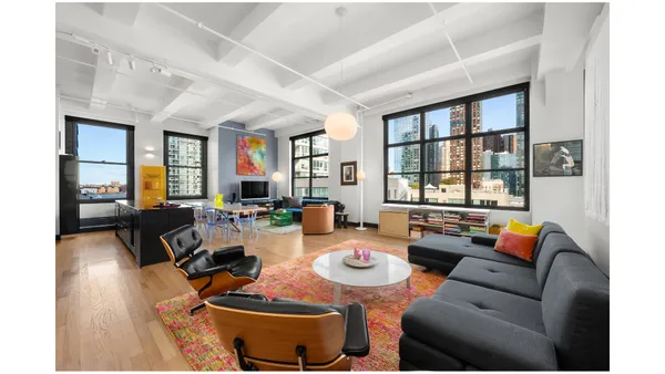 a living room with furniture and a floor to ceiling window