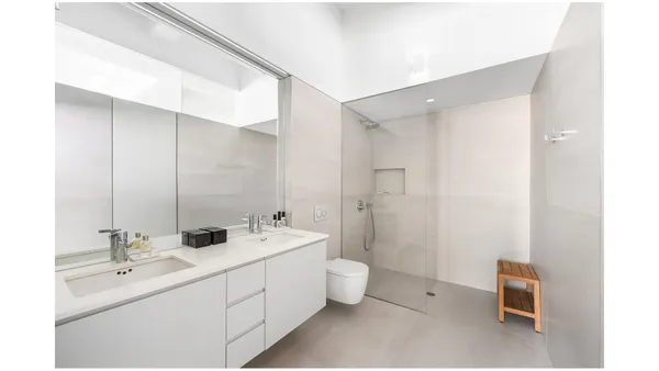 a bedroom with a bed and flat screen tv