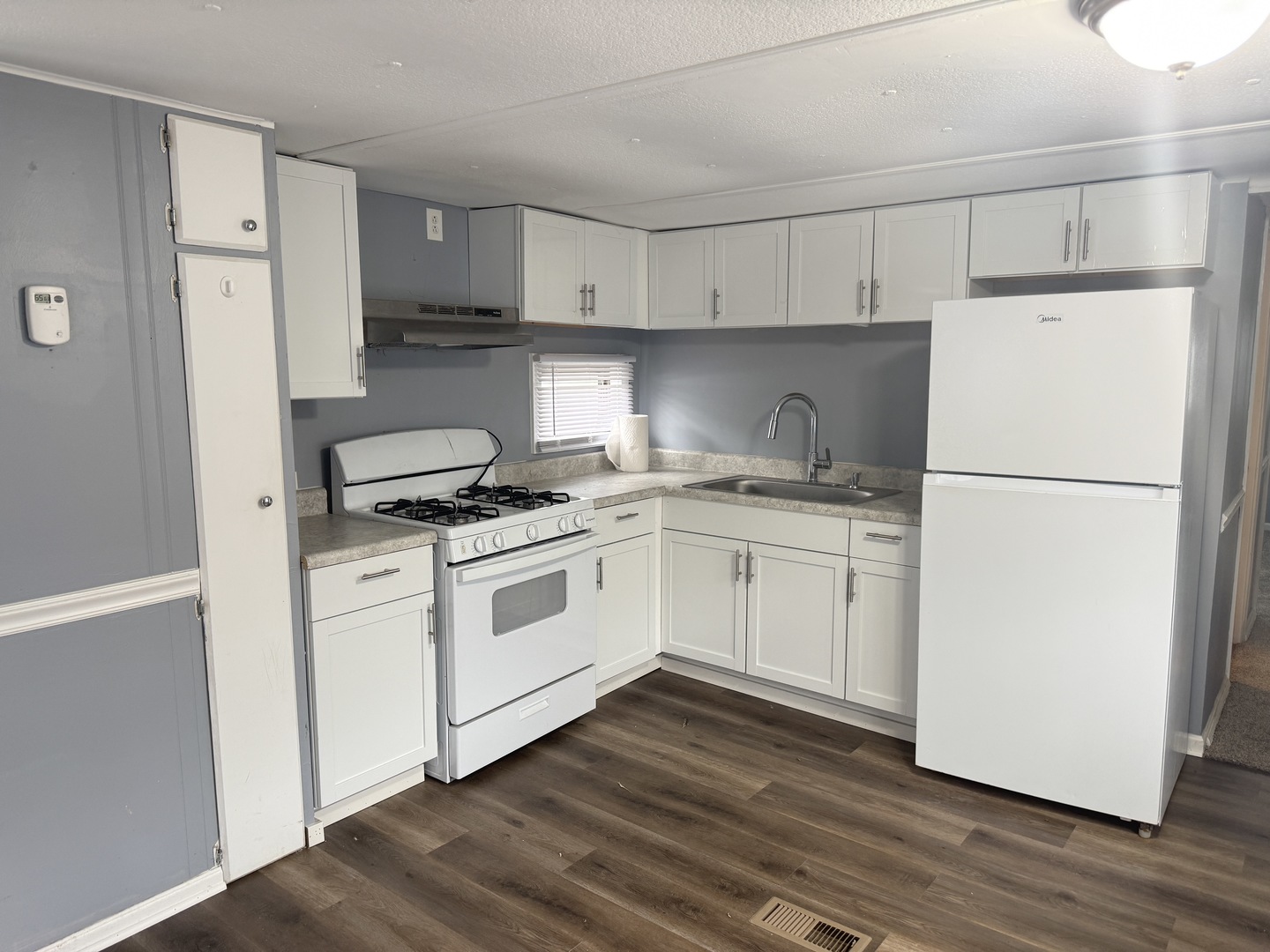 1712 South Dixie Highway, Unit 272 Crete, IL 60417 - Photo 12 of 12 a kitchen with white cabinets and white appliances