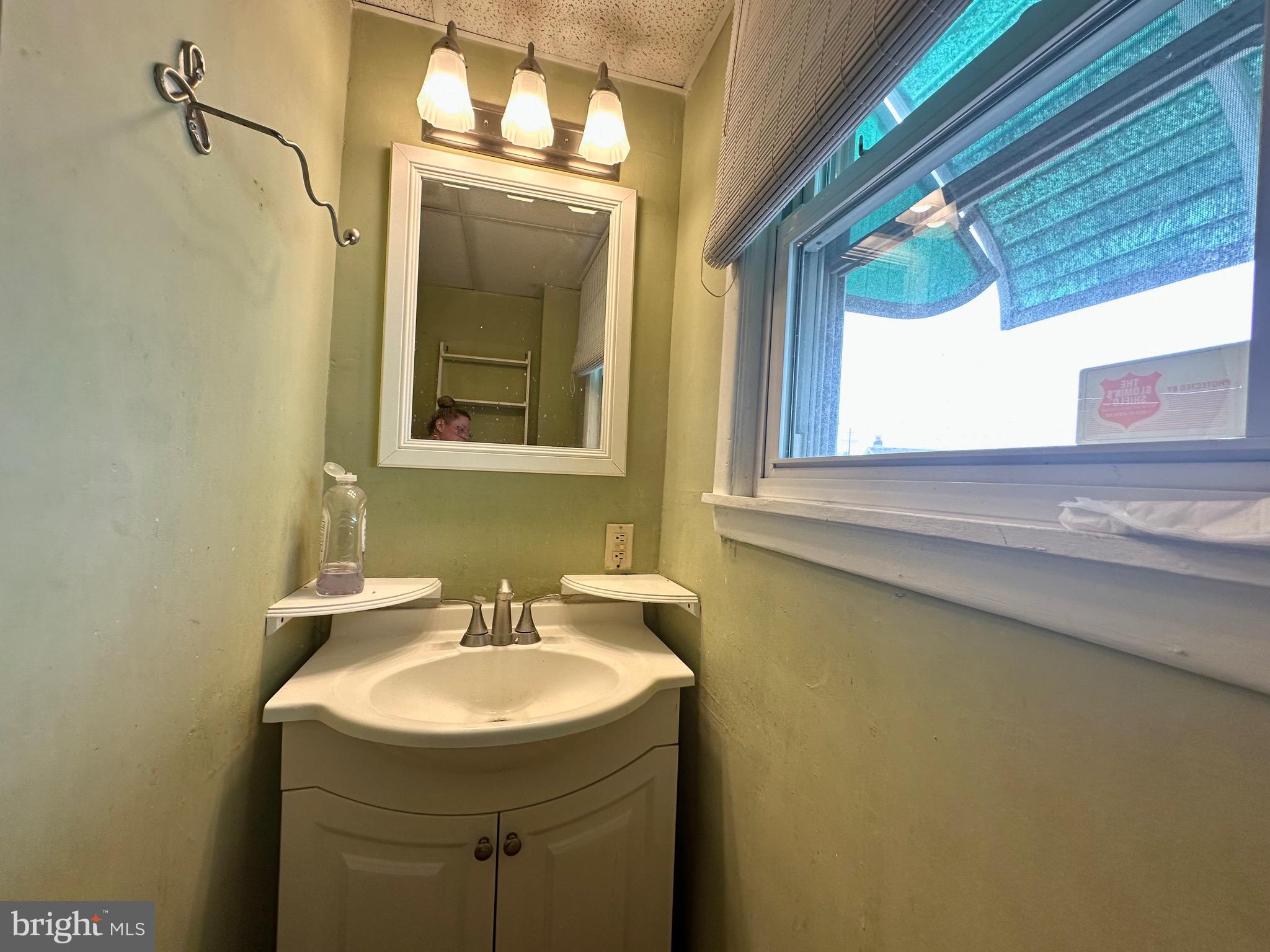 116 Tindall Avenue Hamilton, NJ 08610 - Photo 8 of 12 a bathroom with a sink and a mirror