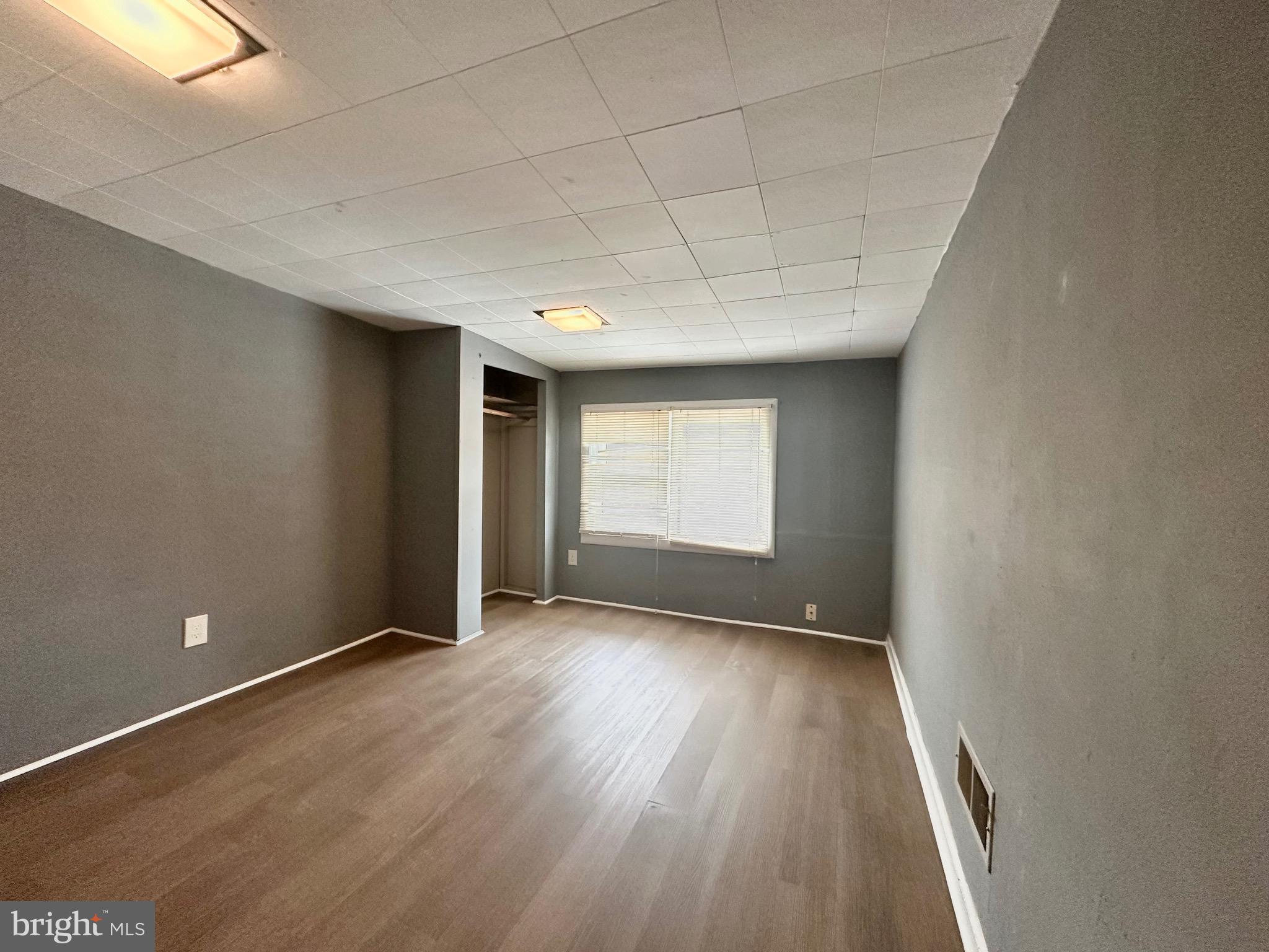 116 Tindall Avenue Hamilton, NJ 08610 - Photo 10 of 12 a view of an empty room with wooden floor and a window