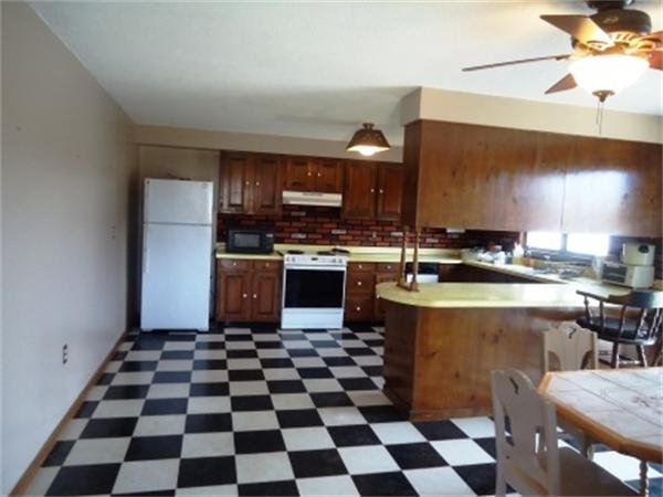 1737 Petersham Road Hardwick, MA 01037 - Photo 9 of 17 a kitchen with a stove a sink and a microwave