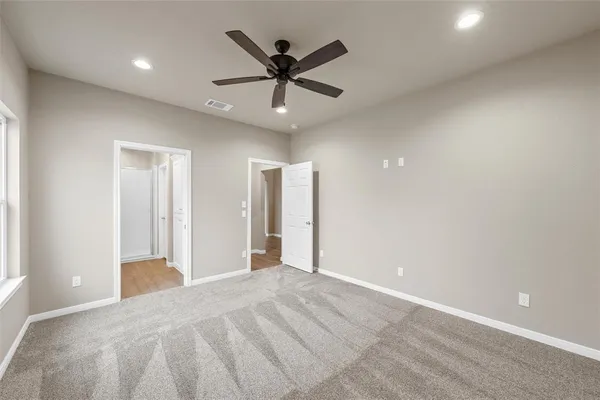 a view of a livingroom with a ceiling fan and wooden floor