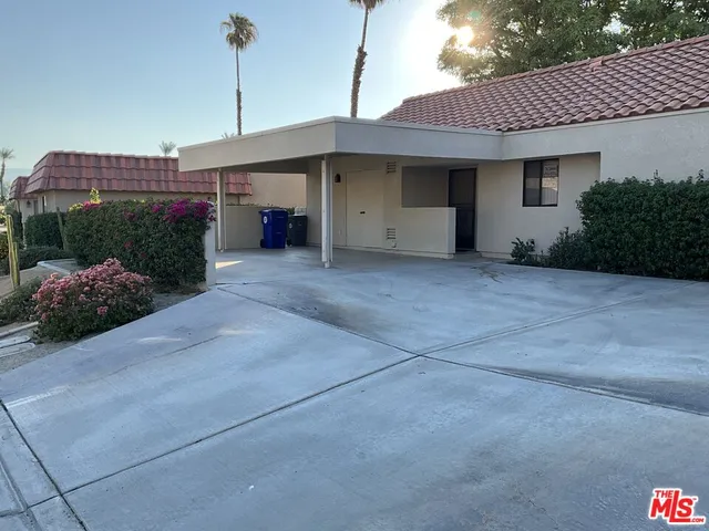 a front view of a house with a garage and lake view