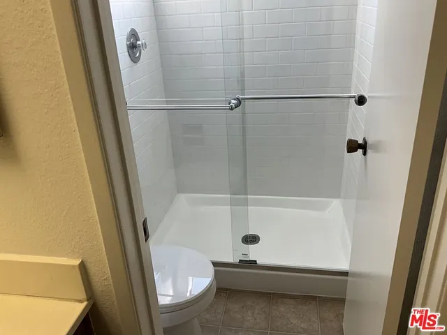 a bathroom with a tub and a toilet