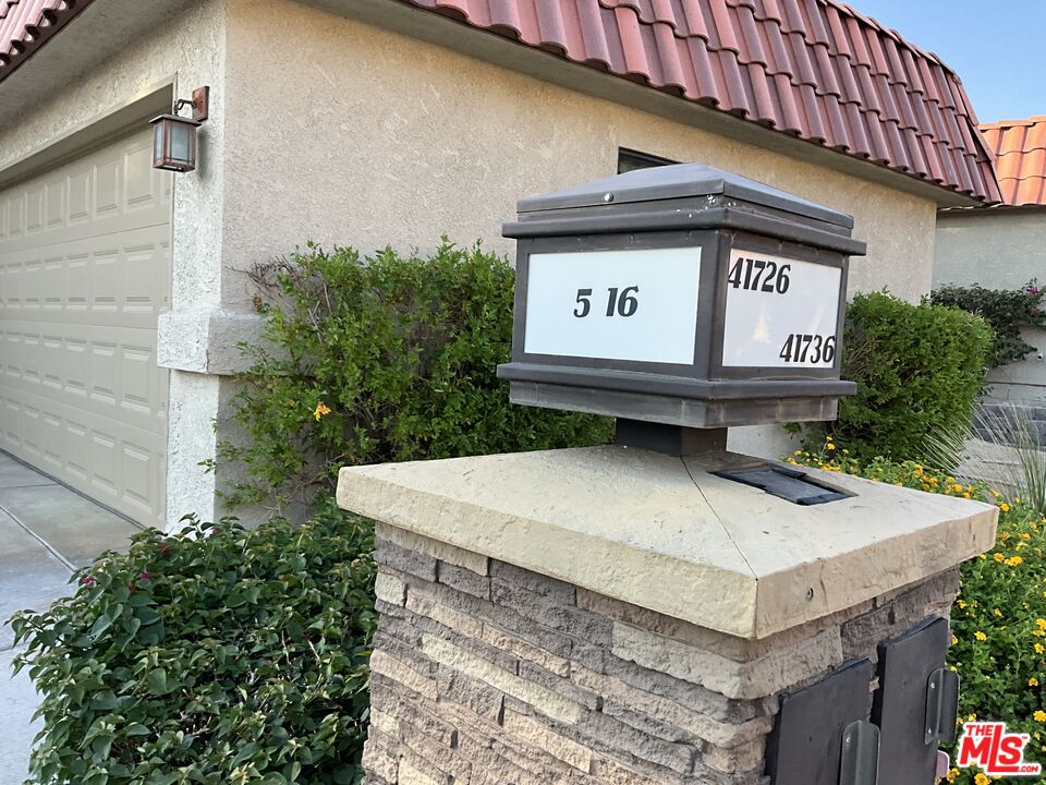 41726 Resorter Boulevard, Unit 516 Palm Desert, CA 92211 - Photo 2 of 17 a view of outdoor space with signage and flags