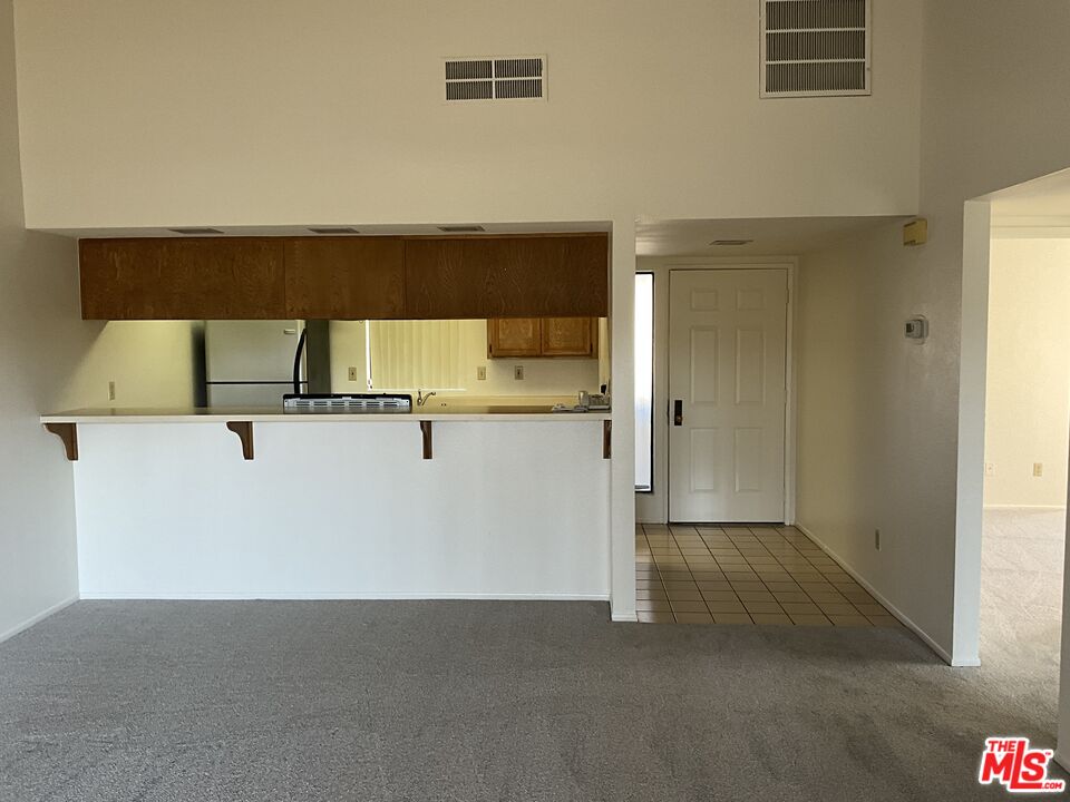41726 Resorter Boulevard, Unit 516 Palm Desert, CA 92211 - Photo 7 of 17 wooden floor and glass door