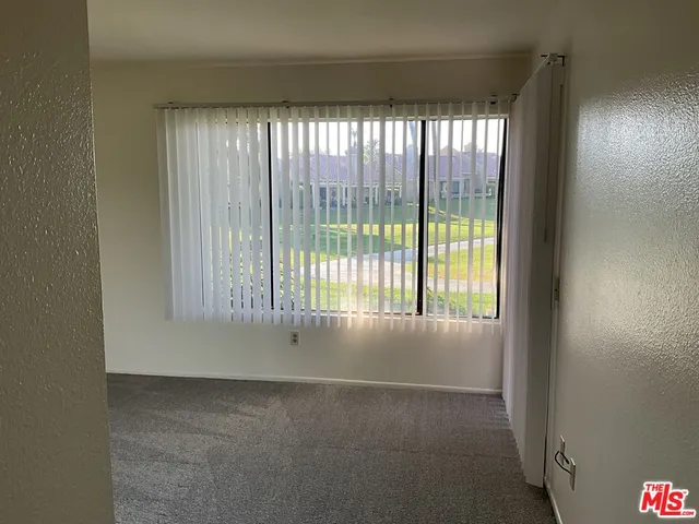 a view of an empty room and a window