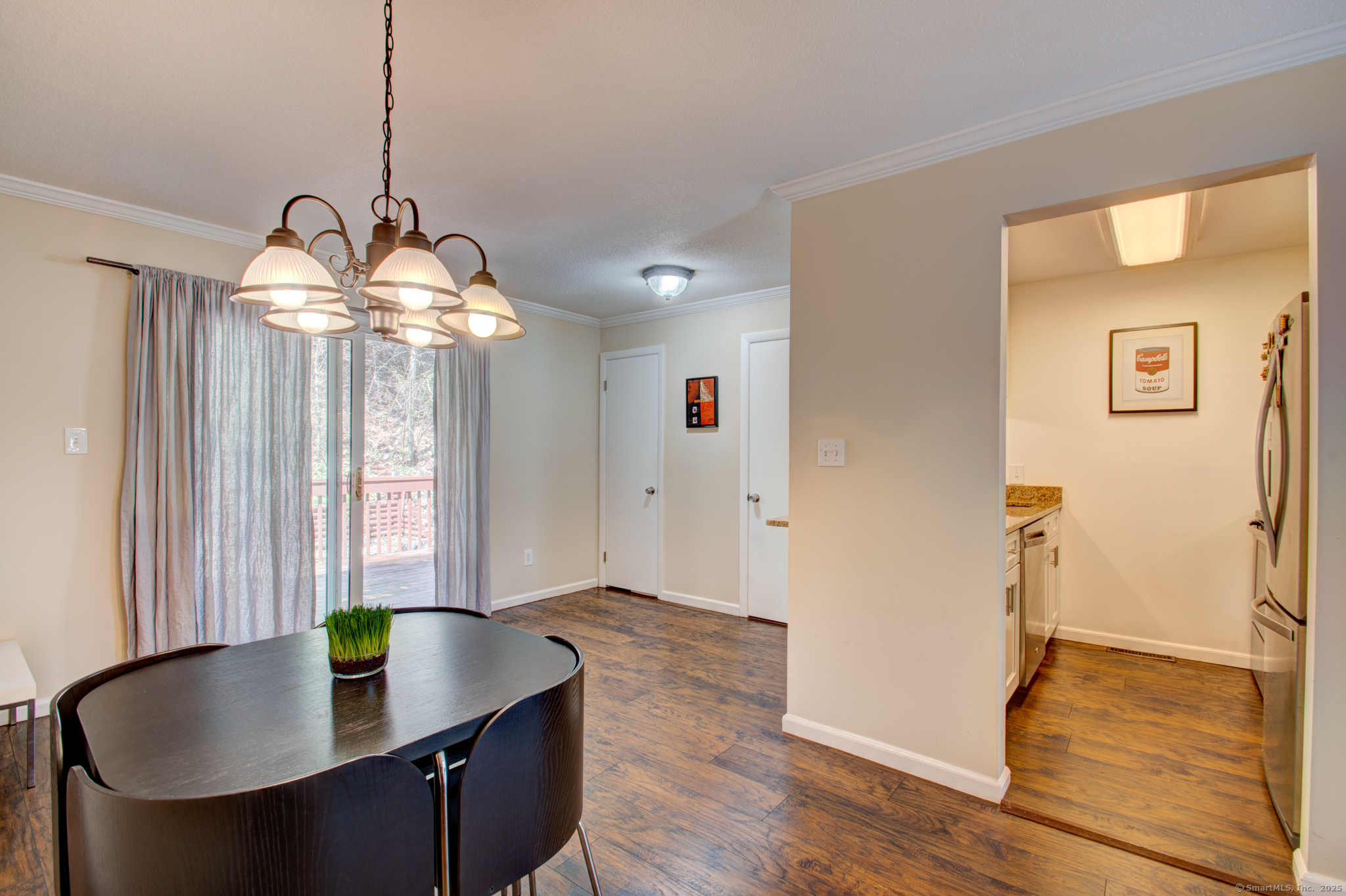 184 Gravel Street, Unit 26 Meriden, CT 06450 - Photo 5 of 27 a dining room with wooden floor a chandelier a wooden table and chairs