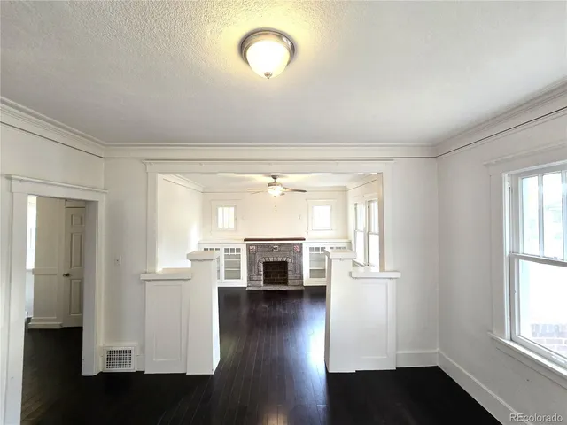 wooden floor in an empty room with a window and wooden floor