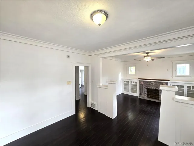 a view of a kitchen with stove and wooden floor