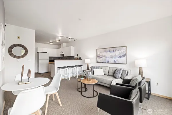 a living room with furniture and a dining table