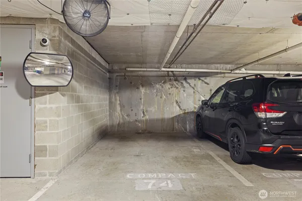 a view of garage with cars